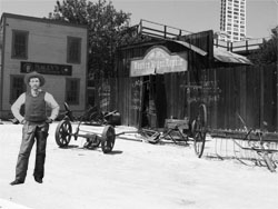 The Smith Tower looms large in the background of this artist's conception of the new wild-west-themed Pioneer Village in downtown Seattle, complete with a costumed panhandler-turned-park-employee.