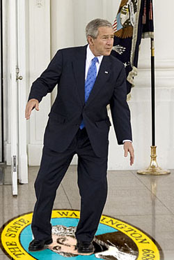 President Bush intentionally treads on the Washington State seal in a medieval show of disrespect.